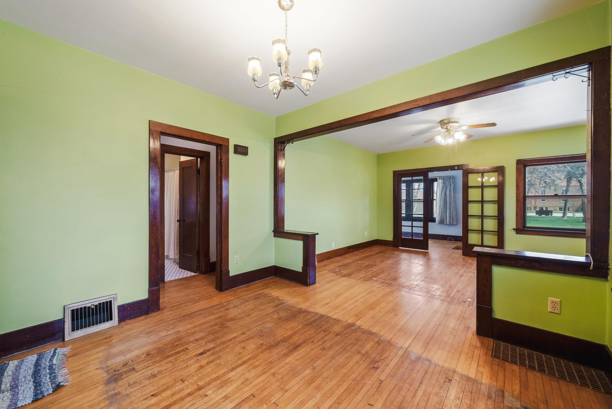 Spacious living and dining areas featuring hardwood floors, rich woodwork, and a classic built-in buffet. The home offers 9’ ceilings on the main level.