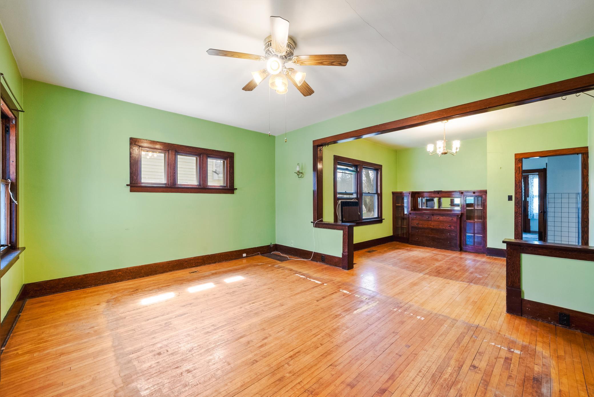 Spacious living and dining areas featuring hardwood floors, rich woodwork, and a classic built-in buffet. The home offers 9’ ceilings on the main level.