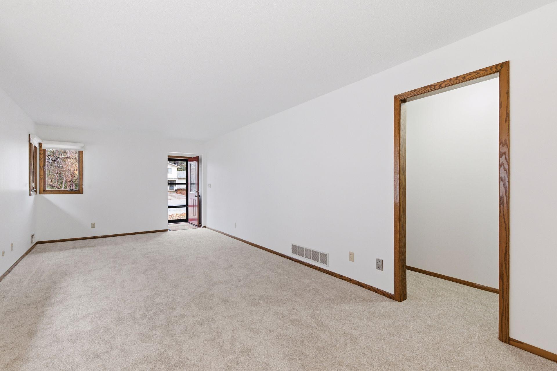 Bright and airy living room with wonderful windows for natural light. The window feature Hunter Douglas blinds.