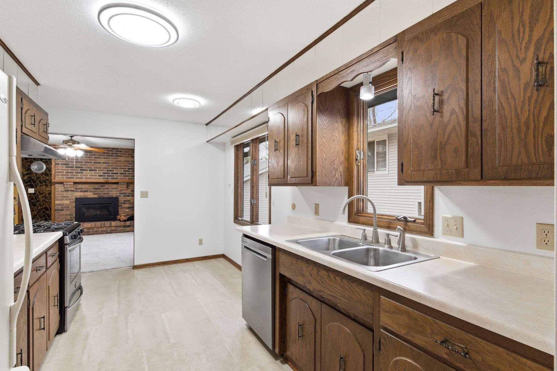 Crisp and clean eat-in kitchen with brand new luxury vinyl flooring and dishwasher.