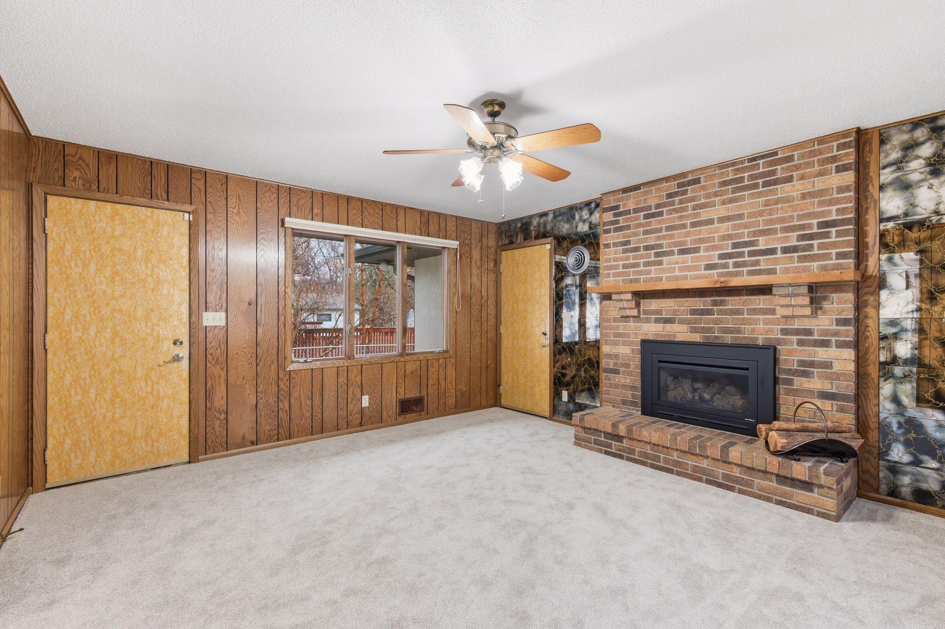 Fantastic main floor family room original flawless paneling, brick Heat & Glo gas fireplace. It offers a walkout to the side patio and garage access.