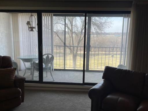 Just off the living room is entry to the glass/screened patio with back lawn and river views.