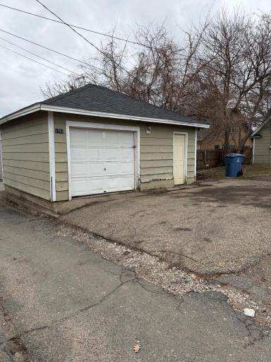 Detached oversized garage with service door and alley accessâideal for storage, workspace, or additional parking.