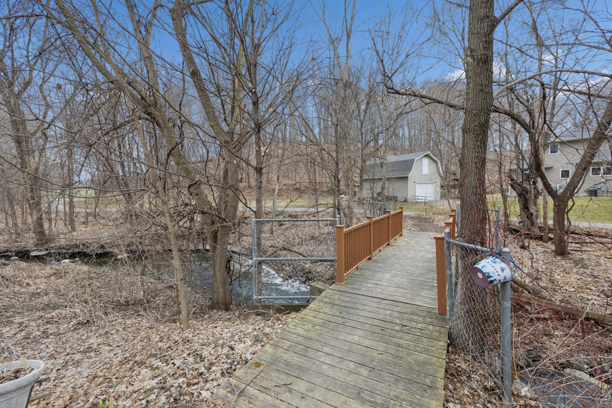 Bridge crossing Rambling Creek at rear of yard to walking trails beyond. Community Preserve Park is within walking/biking distance.