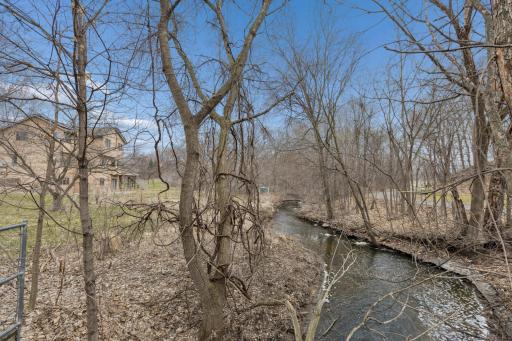 This oversized lot backs to Rambling Creek and protected wetland area for plenty of privacy.