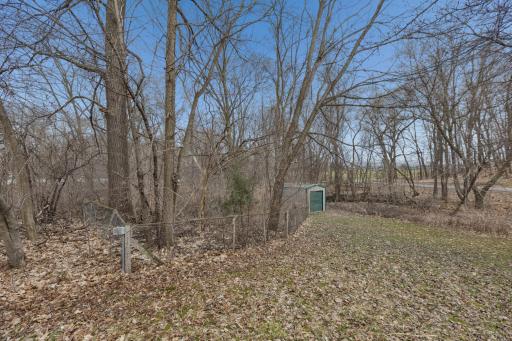 Partial chain link fence on one side of the yard marks the lot line (deemed reliable, not guaranteed)