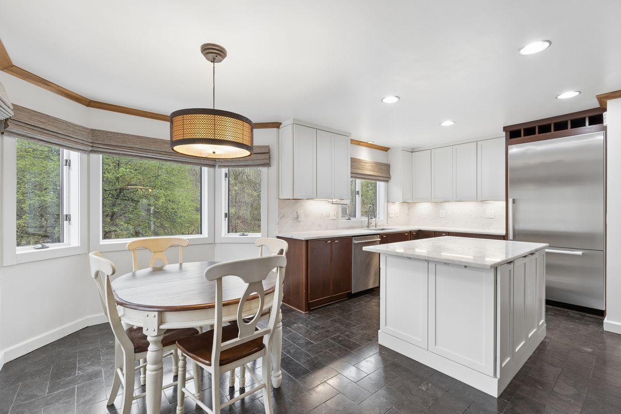 A plethora of white cabinets and recessed lighting