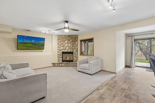 Expansive 9’ ceilings and a striking stone-surround gas fireplace create a warm, inviting setting