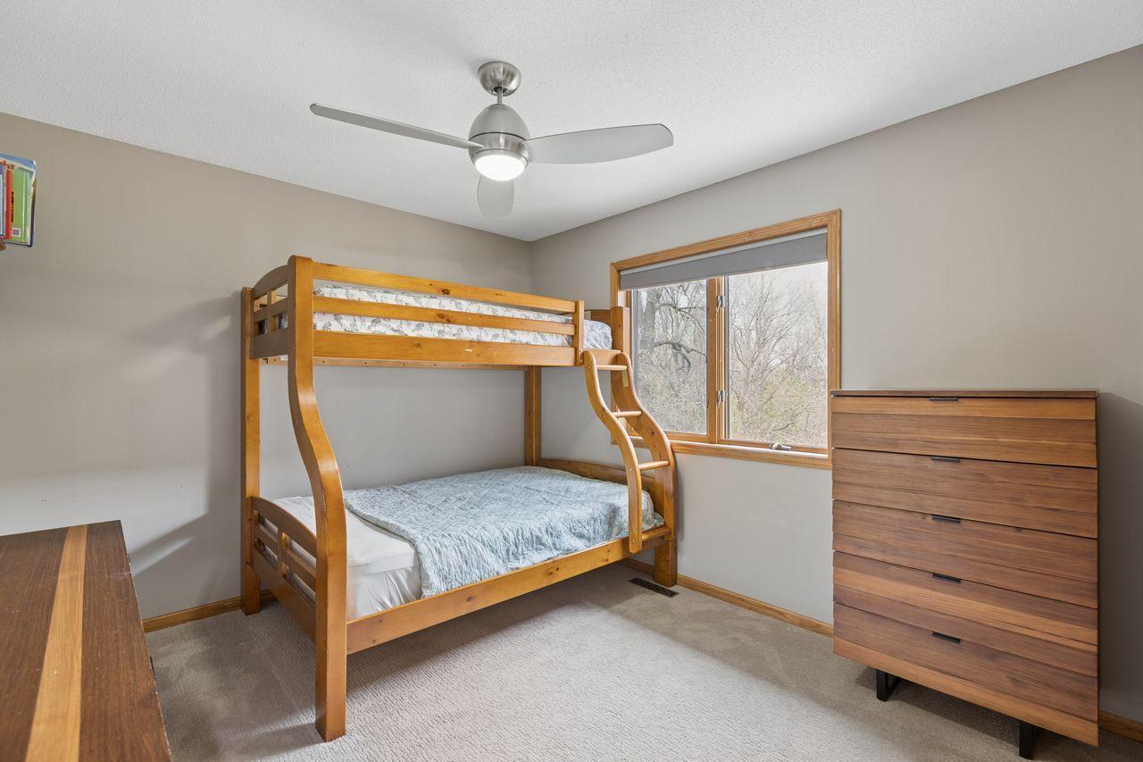2nd of 4 bedrooms upstairs with a modern lighted ceiling fan
