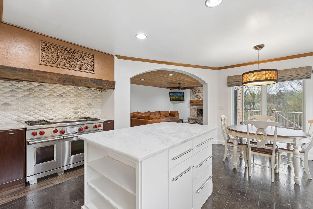 Expansive center island offers abundant space for food preparation and presentation, along with built-in storage