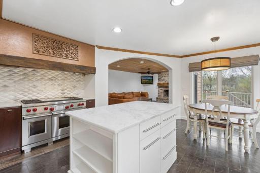 Expansive center island offers abundant space for food preparation and presentation, along with built-in storage