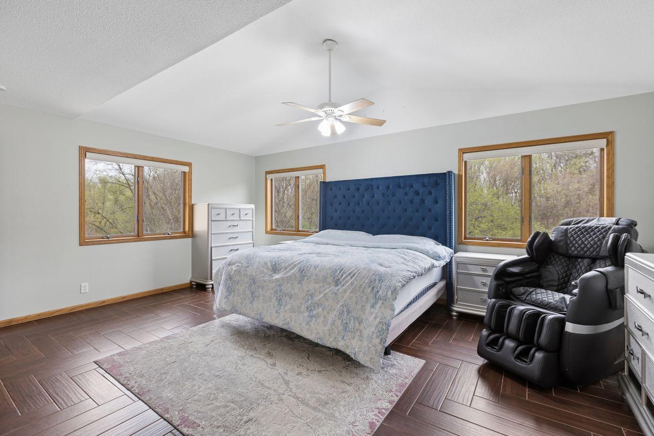 Primary bedroom with vaulted ceilings and views of the backyard, check out all those windows!