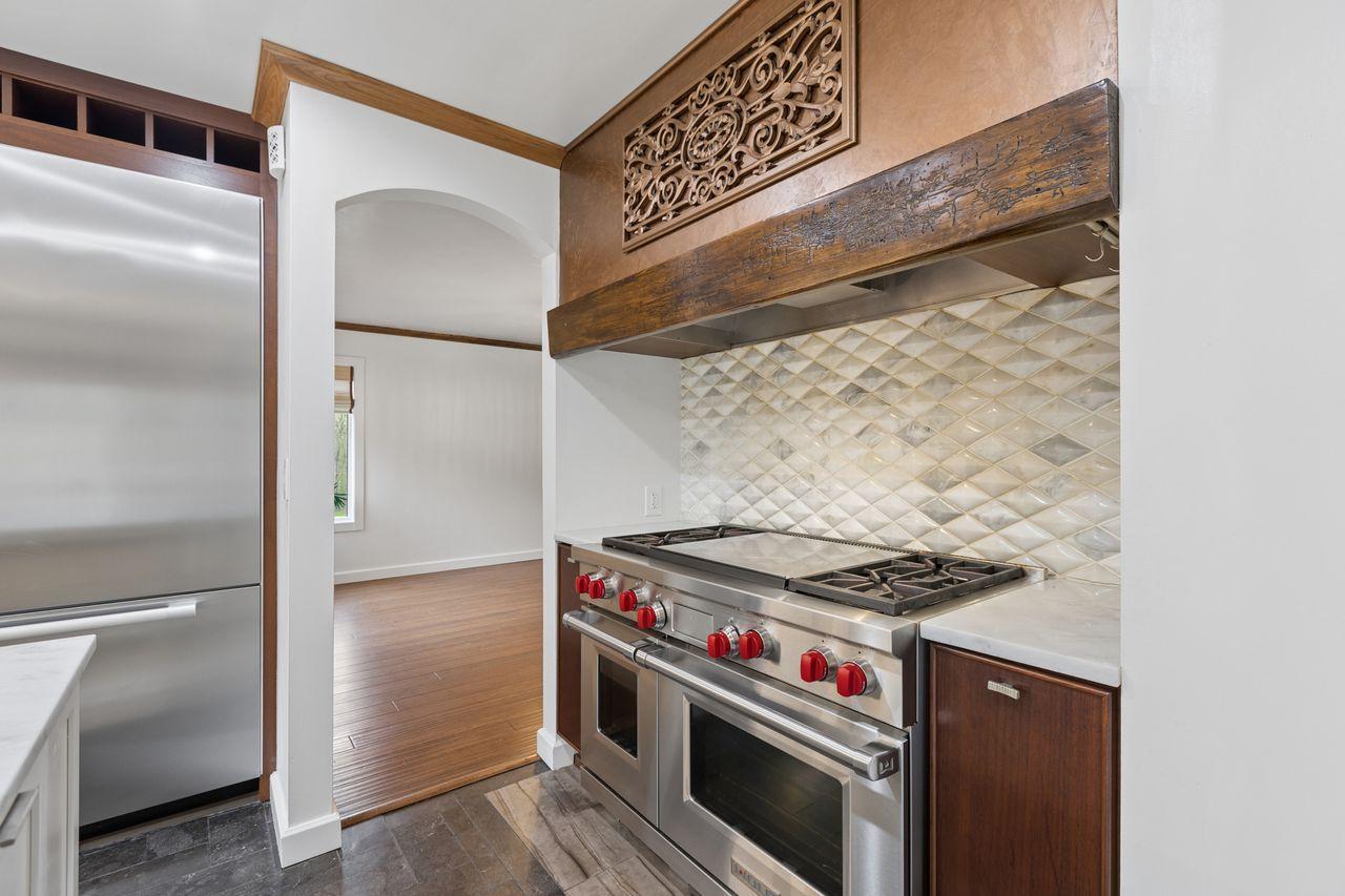 A professional Wolf Hibachi Grill, custom range hood and a gorgeous back splash