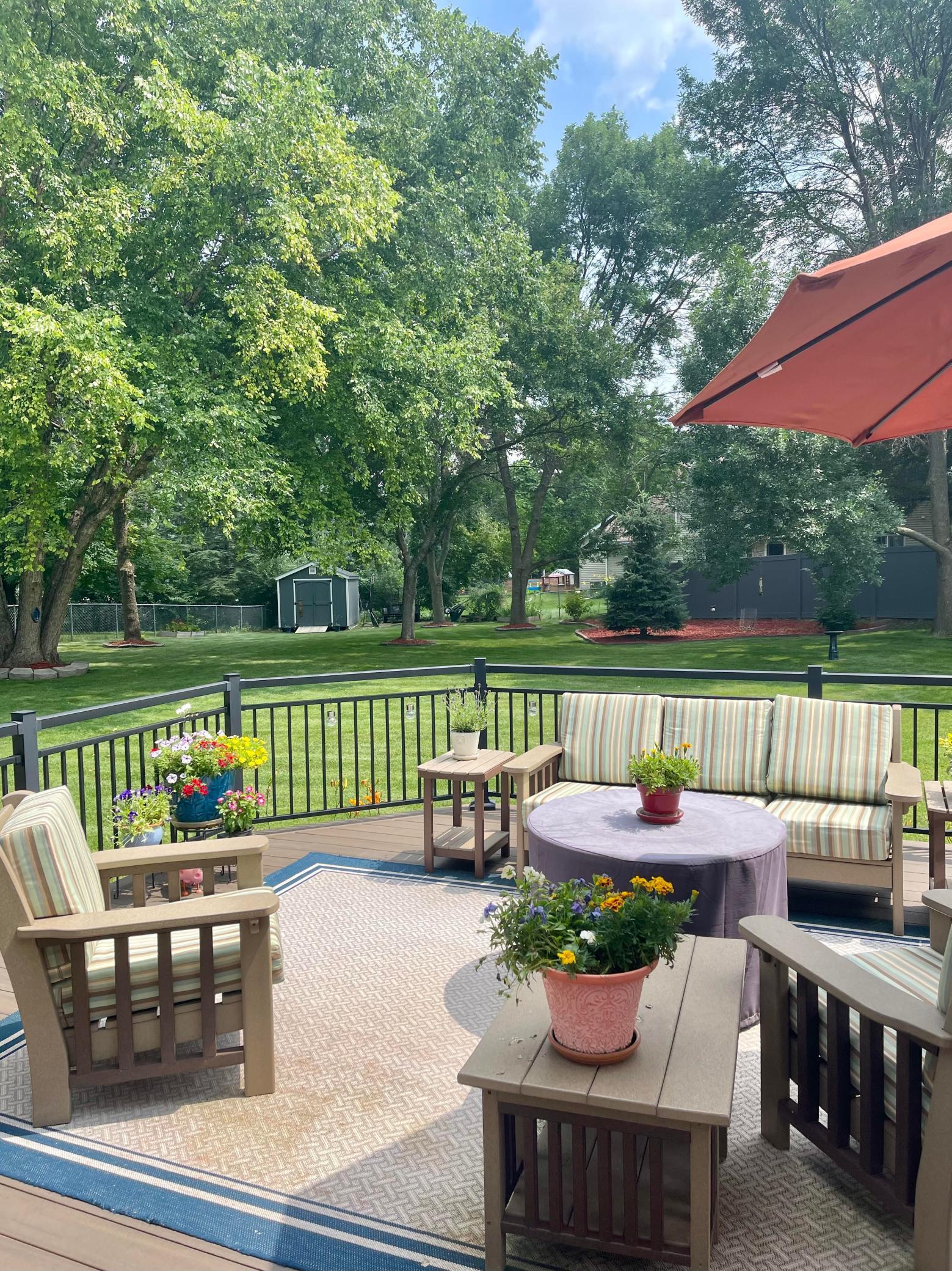 What an exquisite and expansive fenced back yard! Summer photo courtesy of the seller.