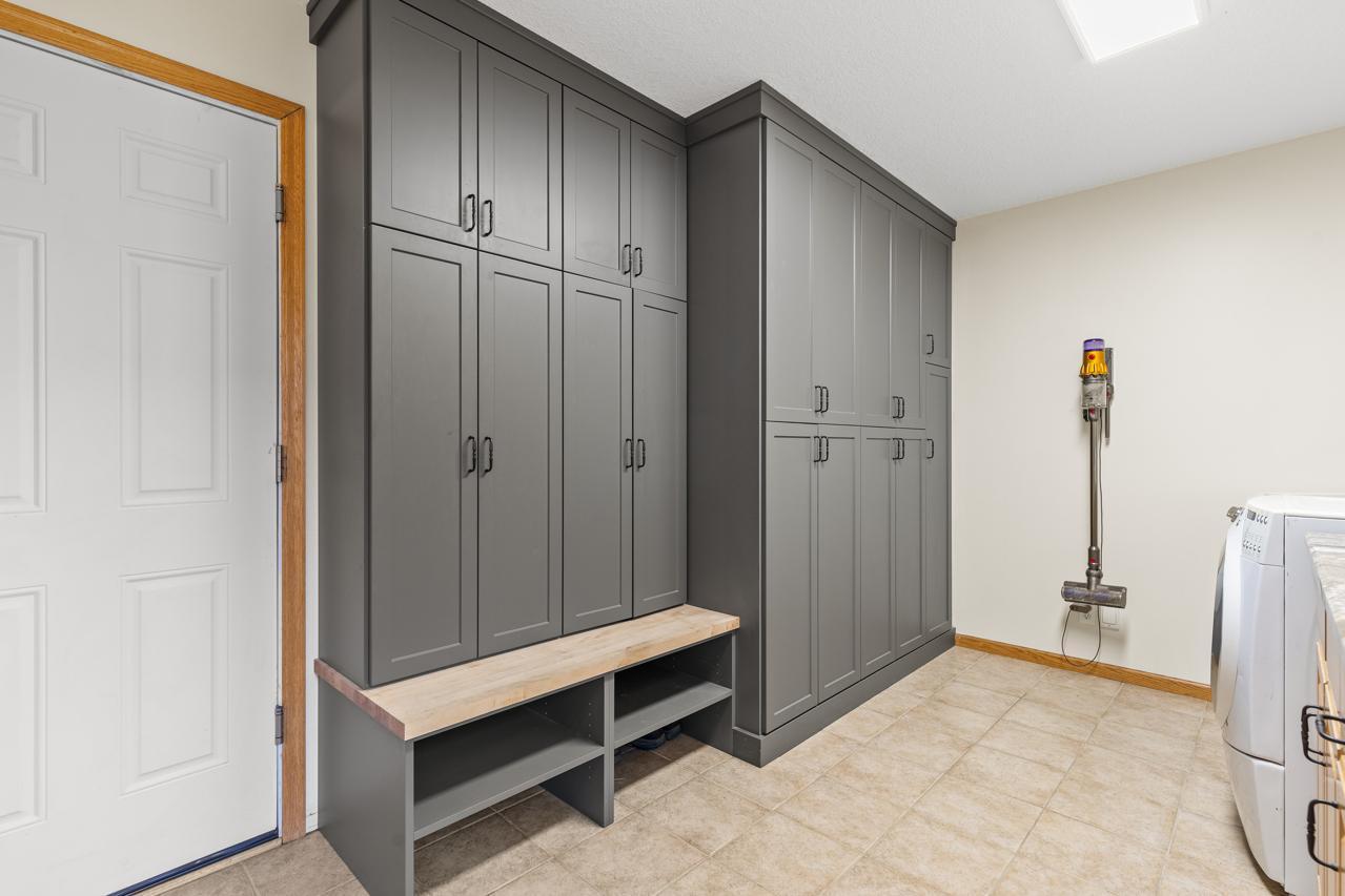 New Custom Built-ins keep everything organized and hidden, creating a neat mudroom.