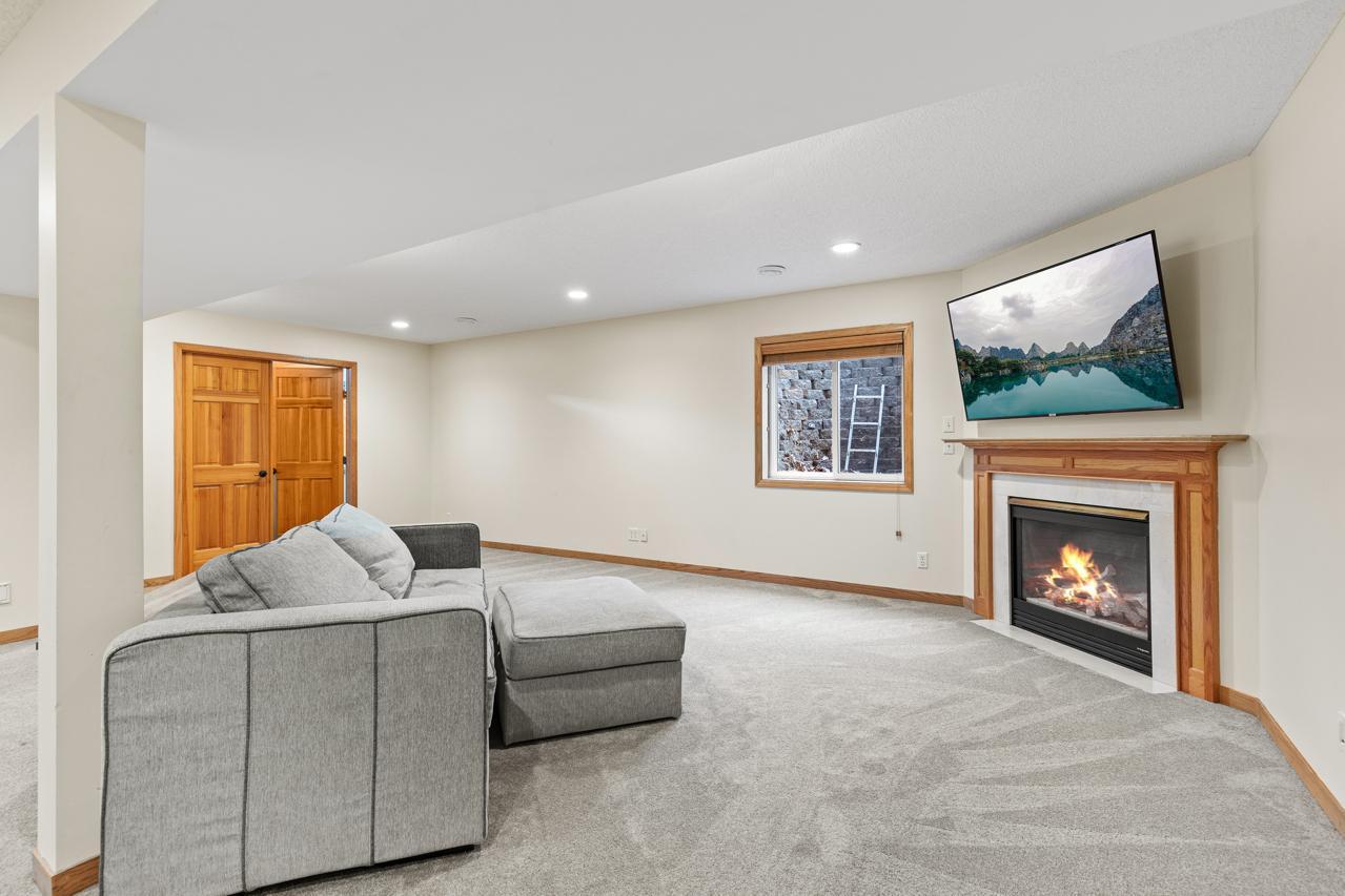 Family room with a gas fireplace and an egress window