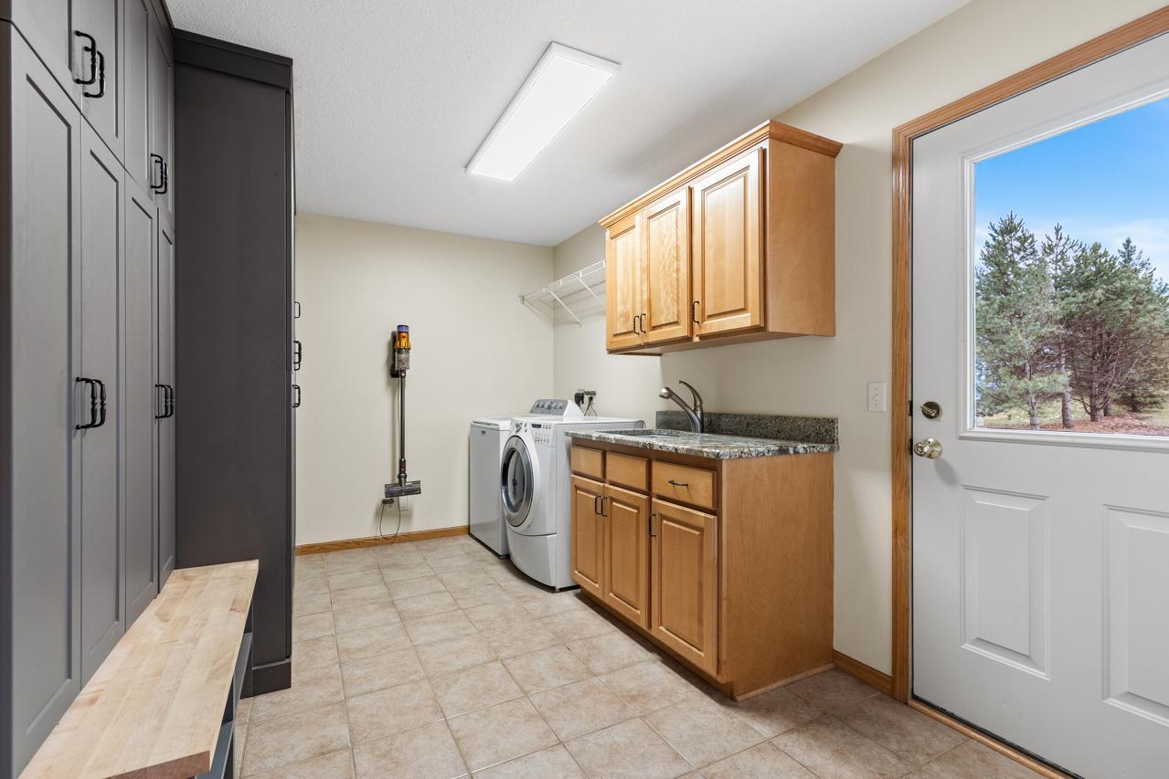 Large mudroom off of garage with back door to back yard
