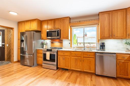The kitchen features stainless steel appliances including a new GE Cafe range (2026), Cambria countertops and backsplash (2021), under cabinet lighting & pantry closet for additional storage.