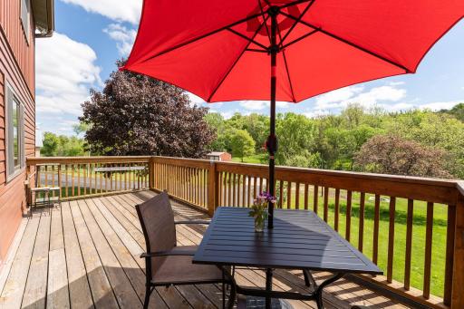 Main level deck overlooking the creek, firepit, garden, and sauna.