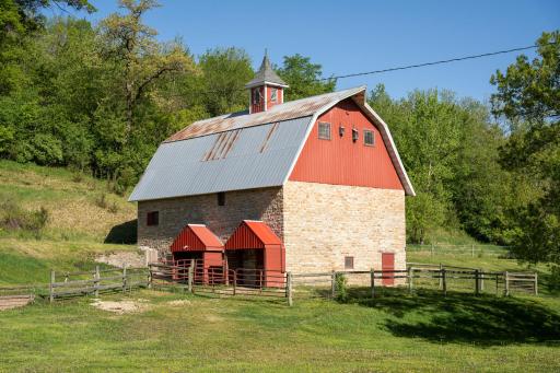 The historic barn is truly a standout feature, beautifully preserved with limestone walls, lower-level box stalls for horses, goats, sheep, or cattle, and an expansive upper level perfect for gatherings, recreation, or hay and feed storage.