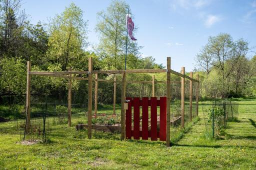 The 24x16 ft fenced garden with water pump system drawing from the creek for convenient watering (2025)