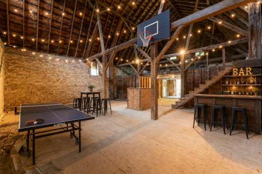 Flexible upper barn level could also serve as a gathering space, recreation area, workout space, entertaining area, or additional storage. Photo virtually staged to help envision its potential.