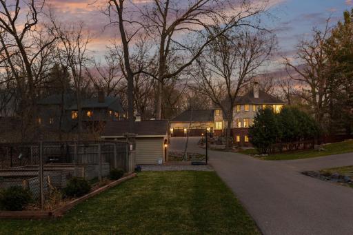 Large Storage Shed and fenced in garden with raised beds.