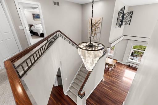 Upper level hallway overlooks large foyer.