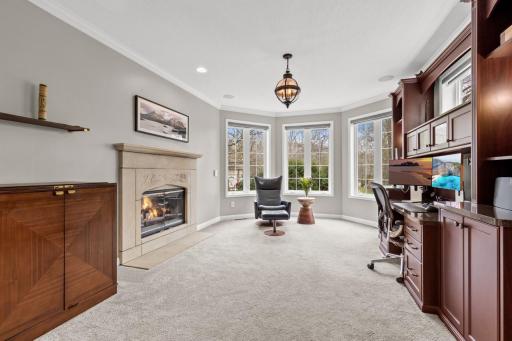 The main floor den/office is right off of the foyer and includes a stunning 2-sided fireplace that is shared with the living room.