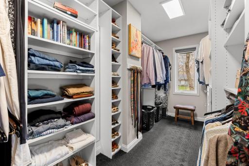 Large primary walk-in closet. The shelf opens up to a secret room.