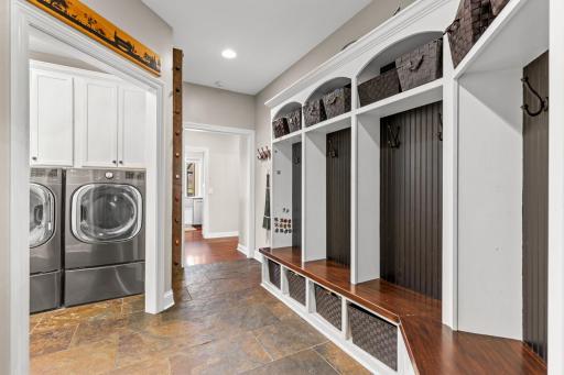 Large Mud room offers ample places for coats and shoes. Leads to a separate laundry room. New washing machine has a second drawer washing machine under washer.