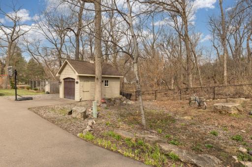 Property includes a large shed along with a fenced in garden with raised beds.