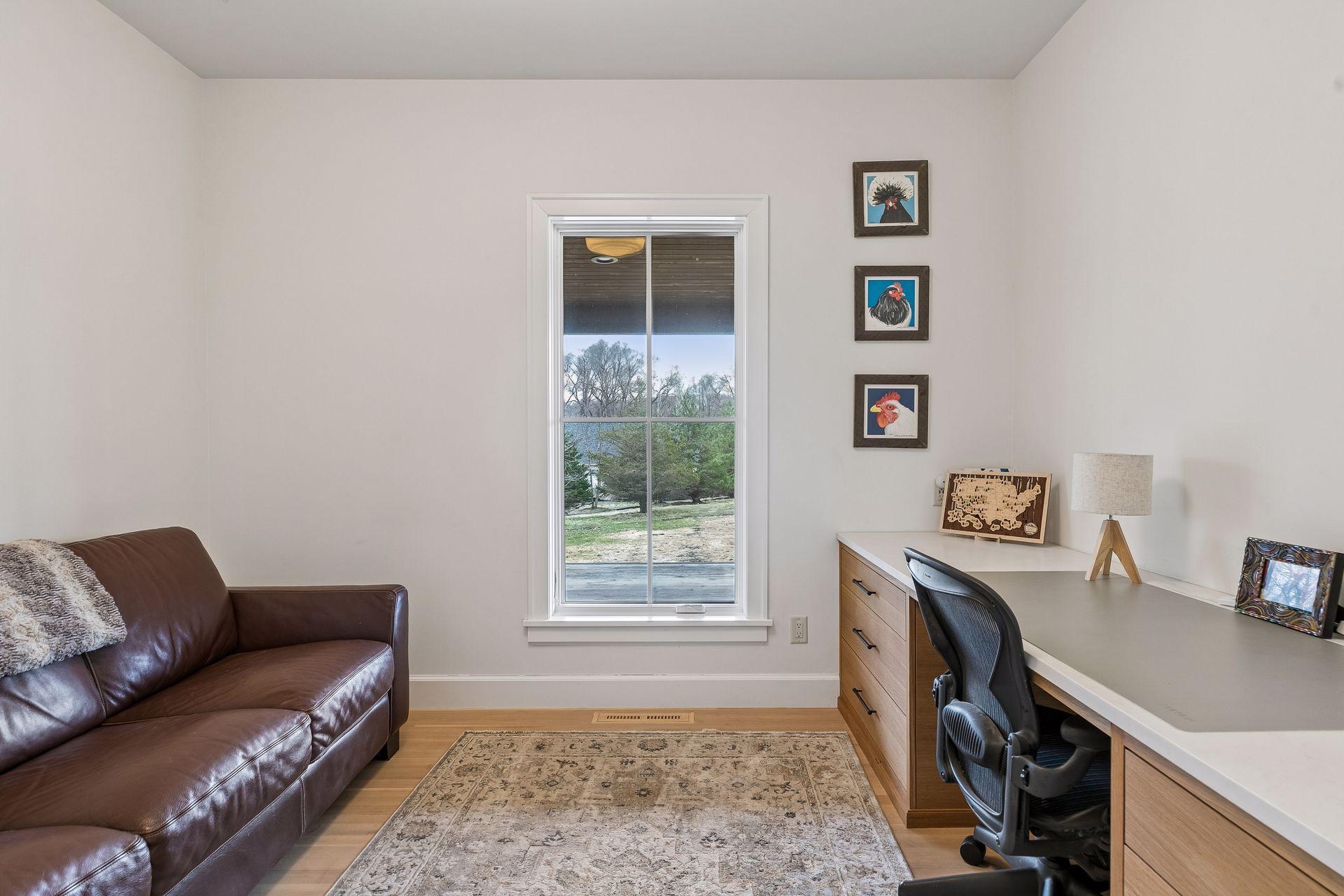 Convenient main floor office with bright widow, hardwood floors, overhead light and substantial built in desk.