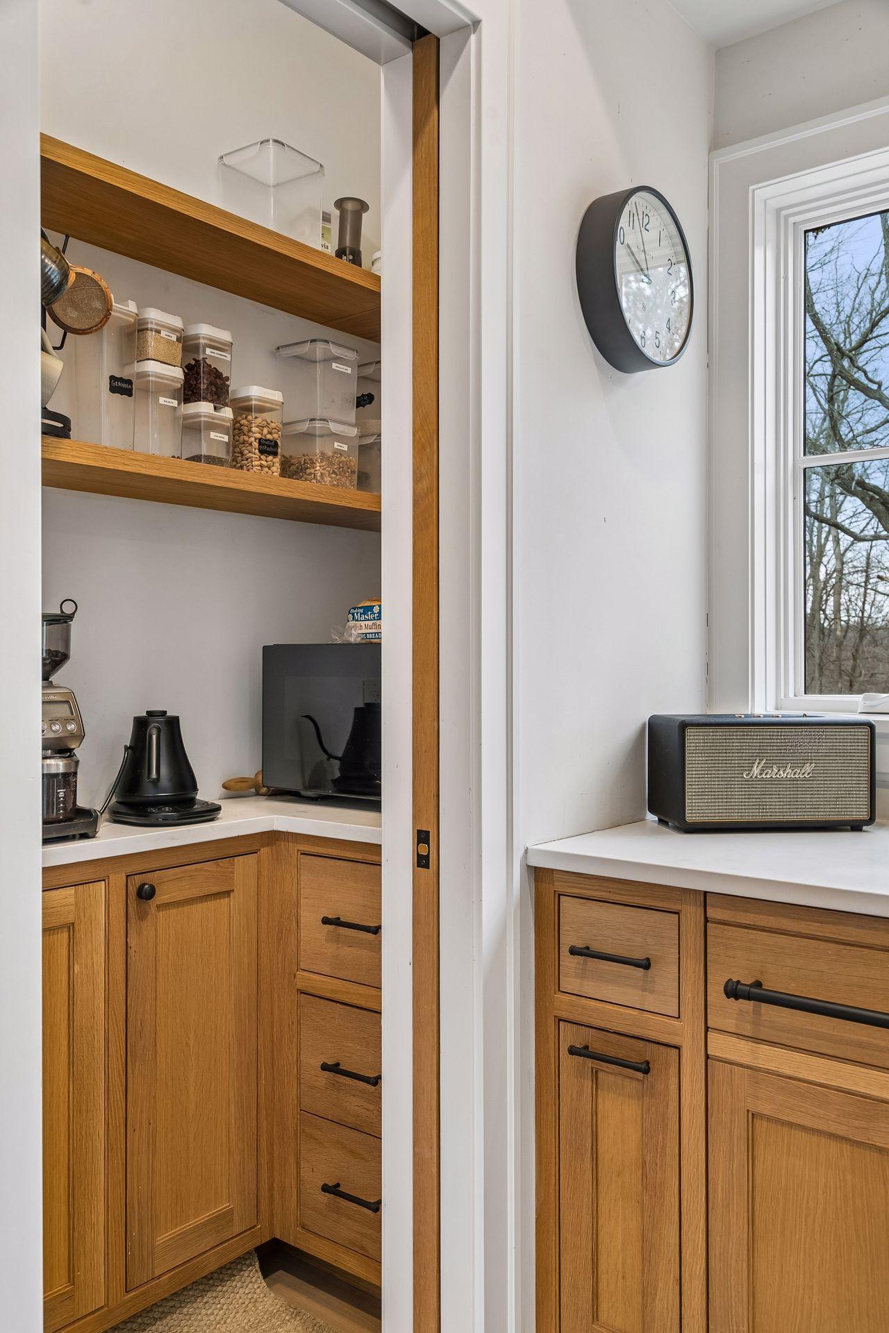 Behind a pocket door you'll find plenty of built in storage!