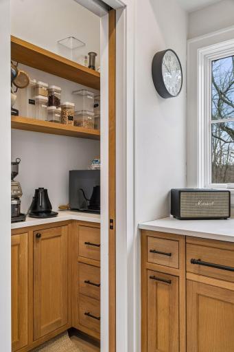 Behind a pocket door you'll find plenty of built in storage!