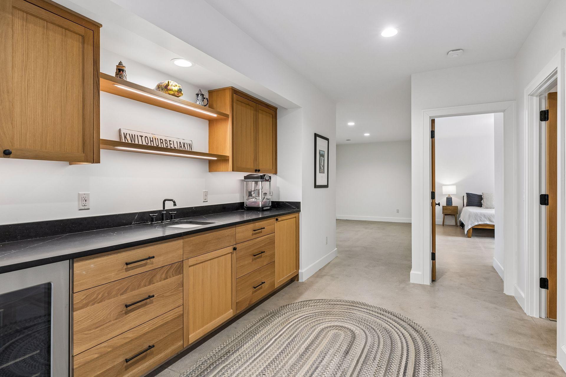 Functional and chic wet bar with ample storage and counter space, conveniently located just off the family room and 5th bedroom, with a 3/4 bath just across the hall.
