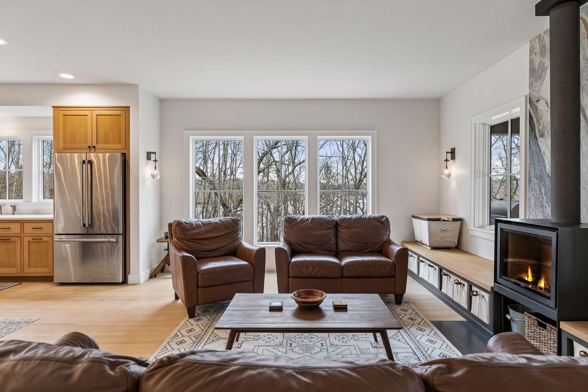 Relax in a living space surrounded by trees with charming views of the lake beyond!