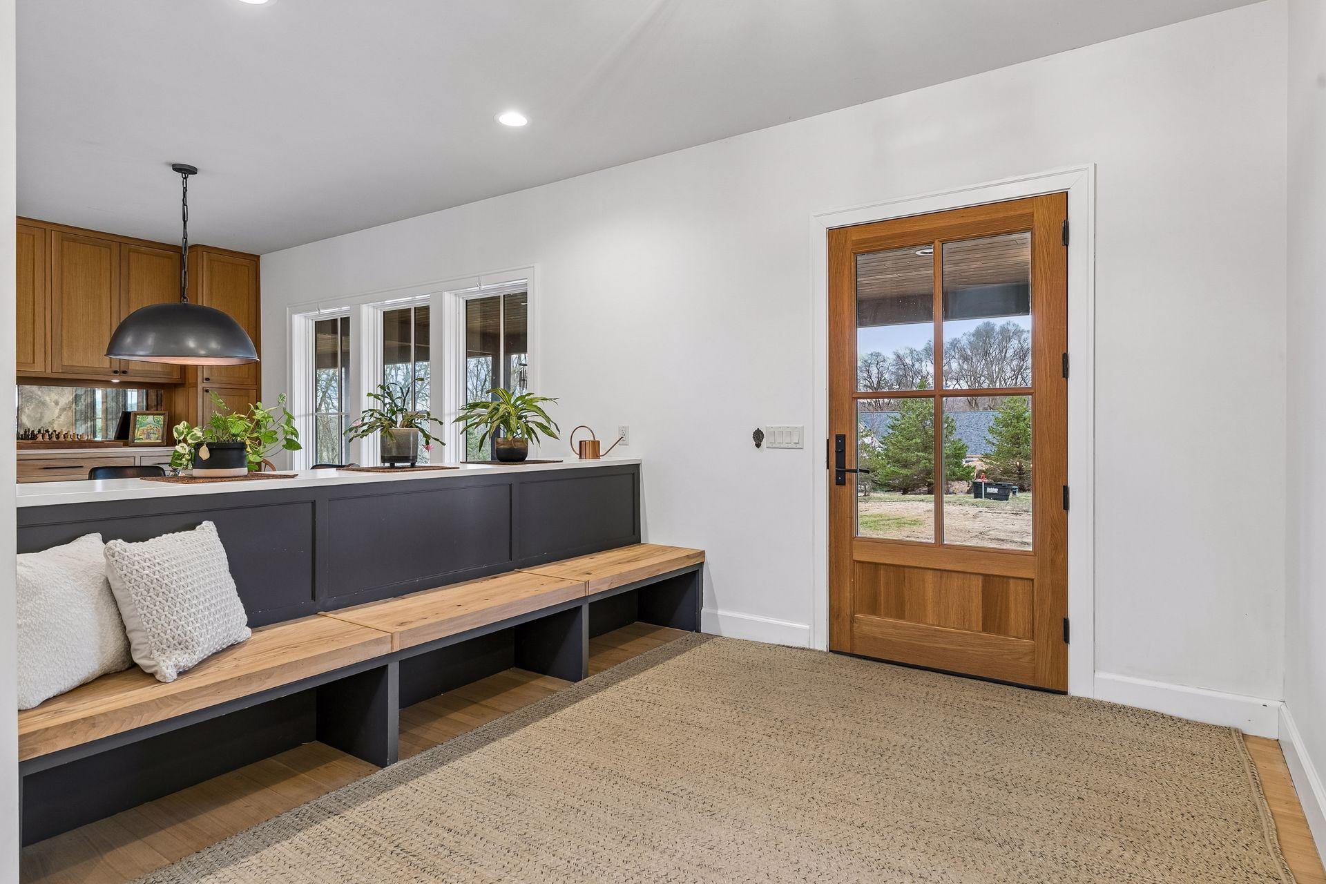 Enter this stunning open concept foyer, complete with hardwood floors, recessed lighting, and intentionally designed built in benches.