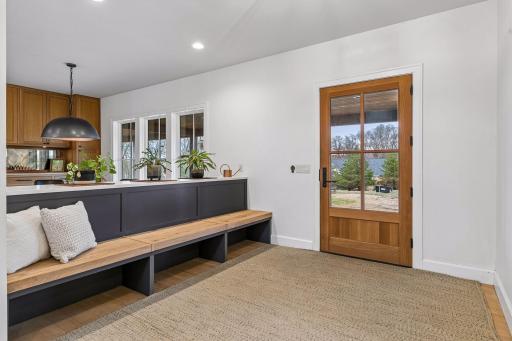 Enter this stunning open concept foyer, complete with hardwood floors, recessed lighting, and intentionally designed built in benches.