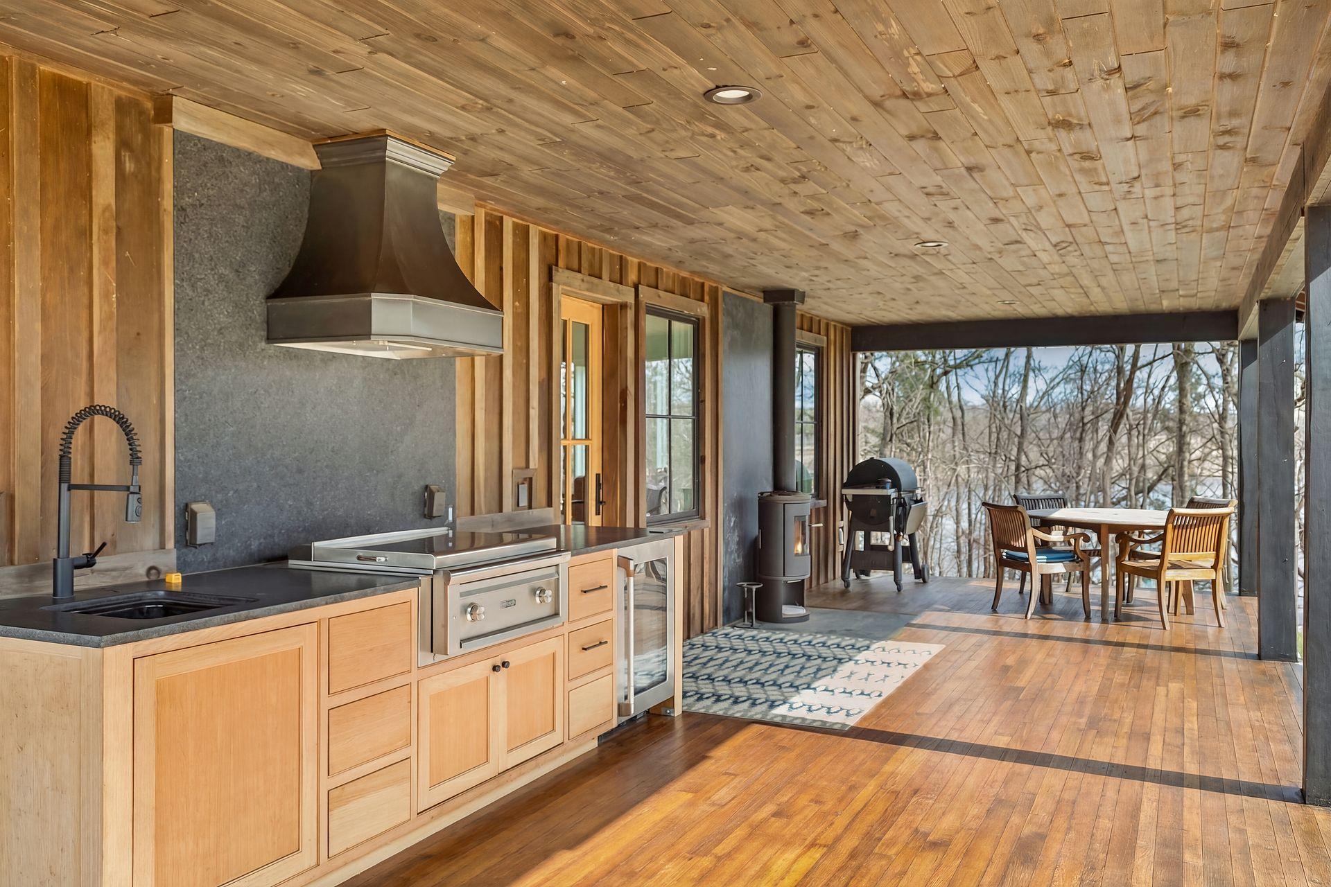 Spectacular outdoor kitchen! Fully equipped with beverage fridge, sink, gas stove with hood, and plenty of room for seating and dining.