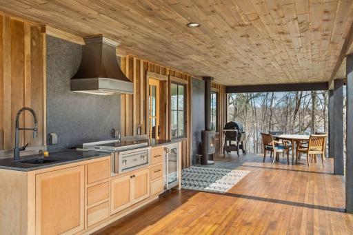 Spectacular outdoor kitchen! Fully equipped with beverage fridge, sink, gas stove with hood, and plenty of room for seating and dining.