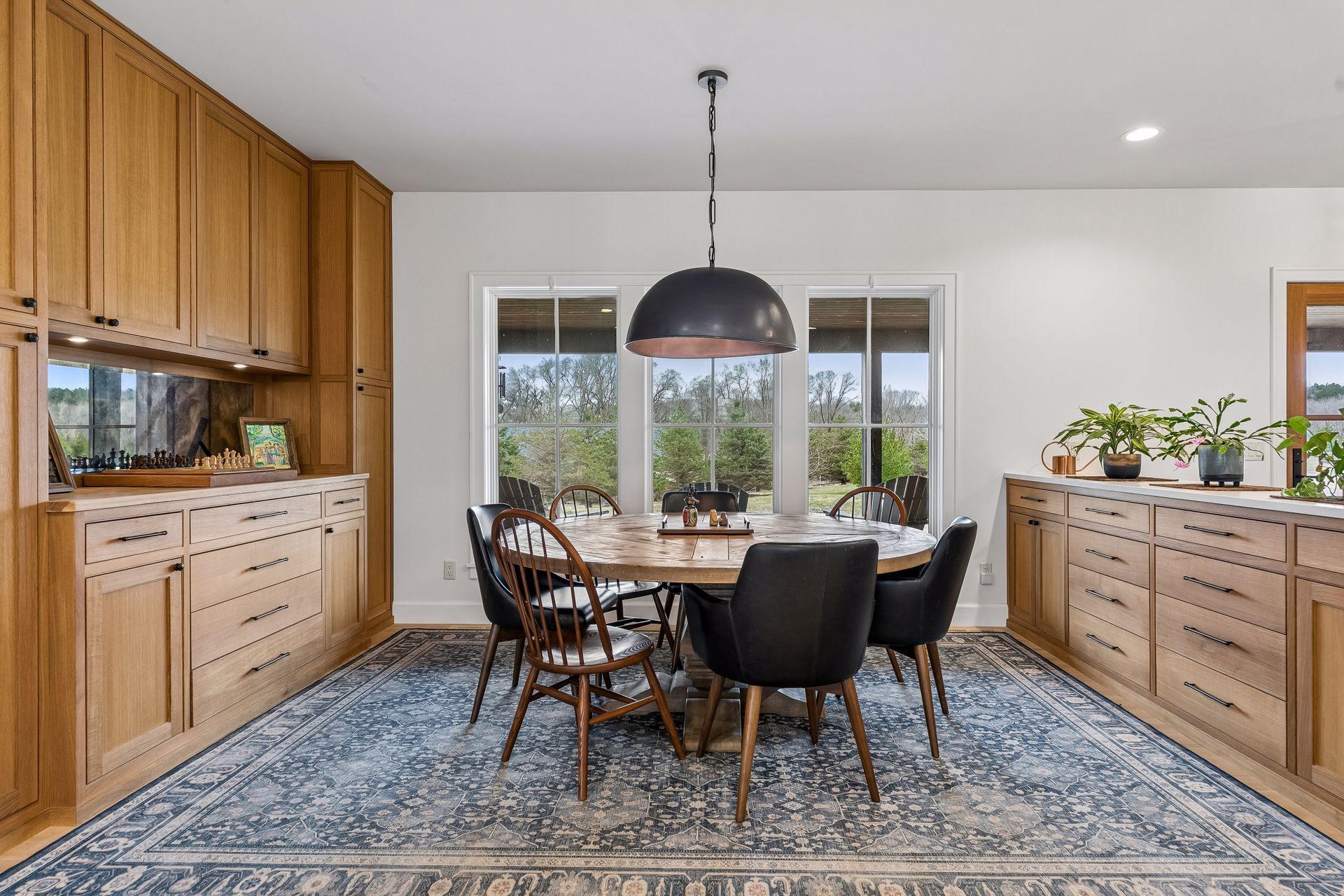 Entertain in style in this exquisite dining room, complete with a built in buffet, ample storage, 3 sunlit windows, and a striking modern chandelier.