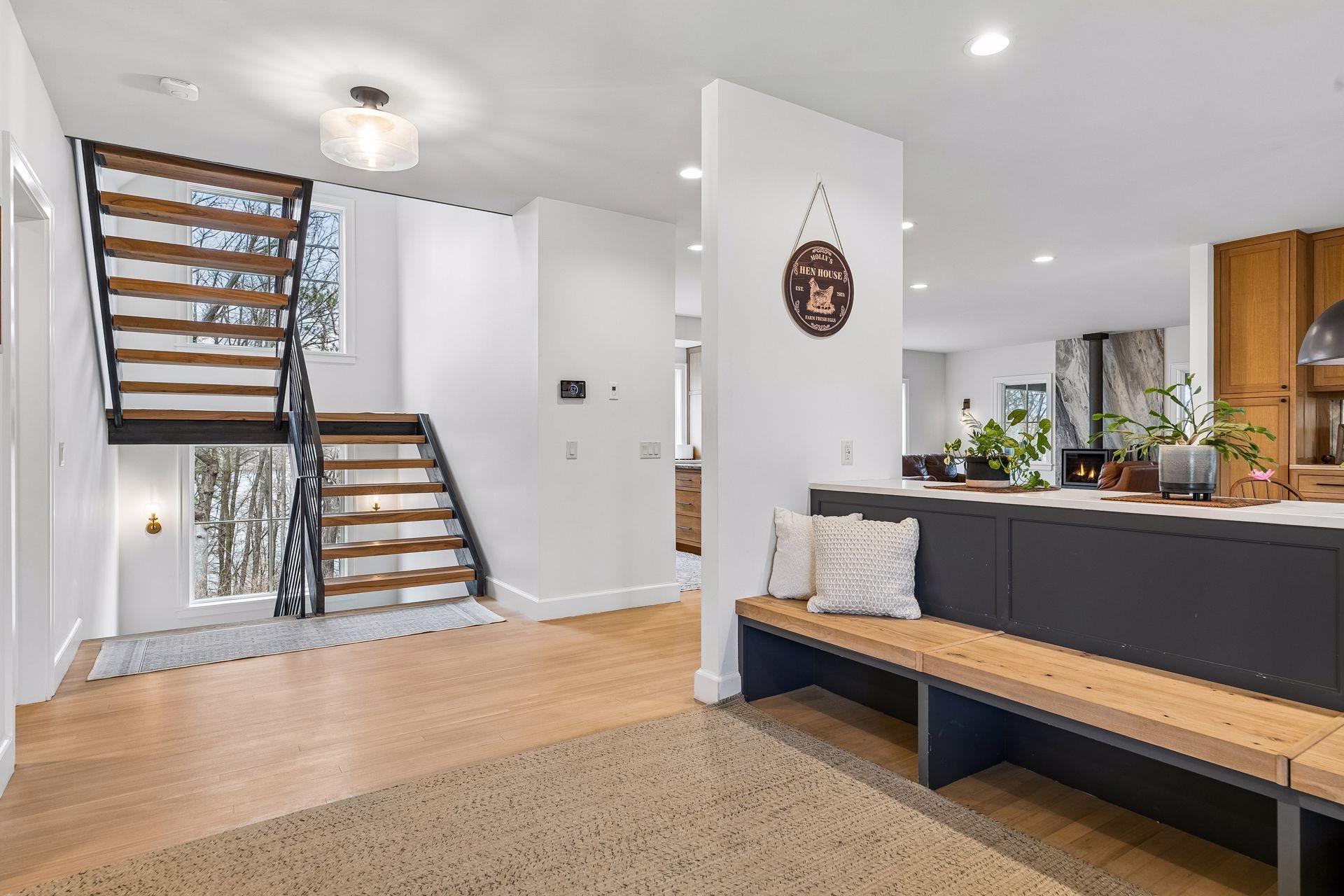 When you walk into the home you'll fall in love. Take in the full open view of the entertaining space. Look past the stairs to see views of the lake. Stair treads from wood harvested on the lot!