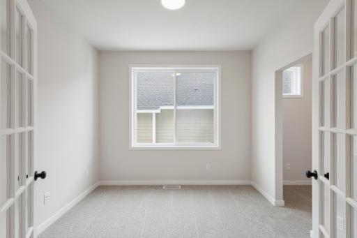 A stunning flex room with French doors adds both charm and flexibility, perfect for a home office, study, playroom, or additional sitting area.