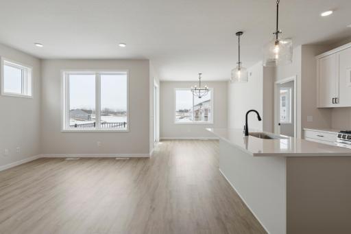 The beautiful kitchen opens up to the gathering room and informal dining room. The windows are spectacular!