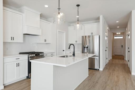 The kitchen is equipped with modern stainless steel appliances, offering a clean, cohesive, and stylish look.