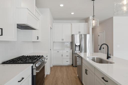 Kitchen boasts a well-planned layout with generous counter space and plentiful cabinetry for storage.