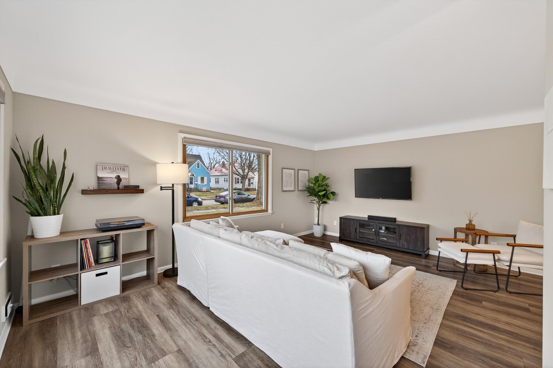 Bright spacious living room with lots of cove ceilings!