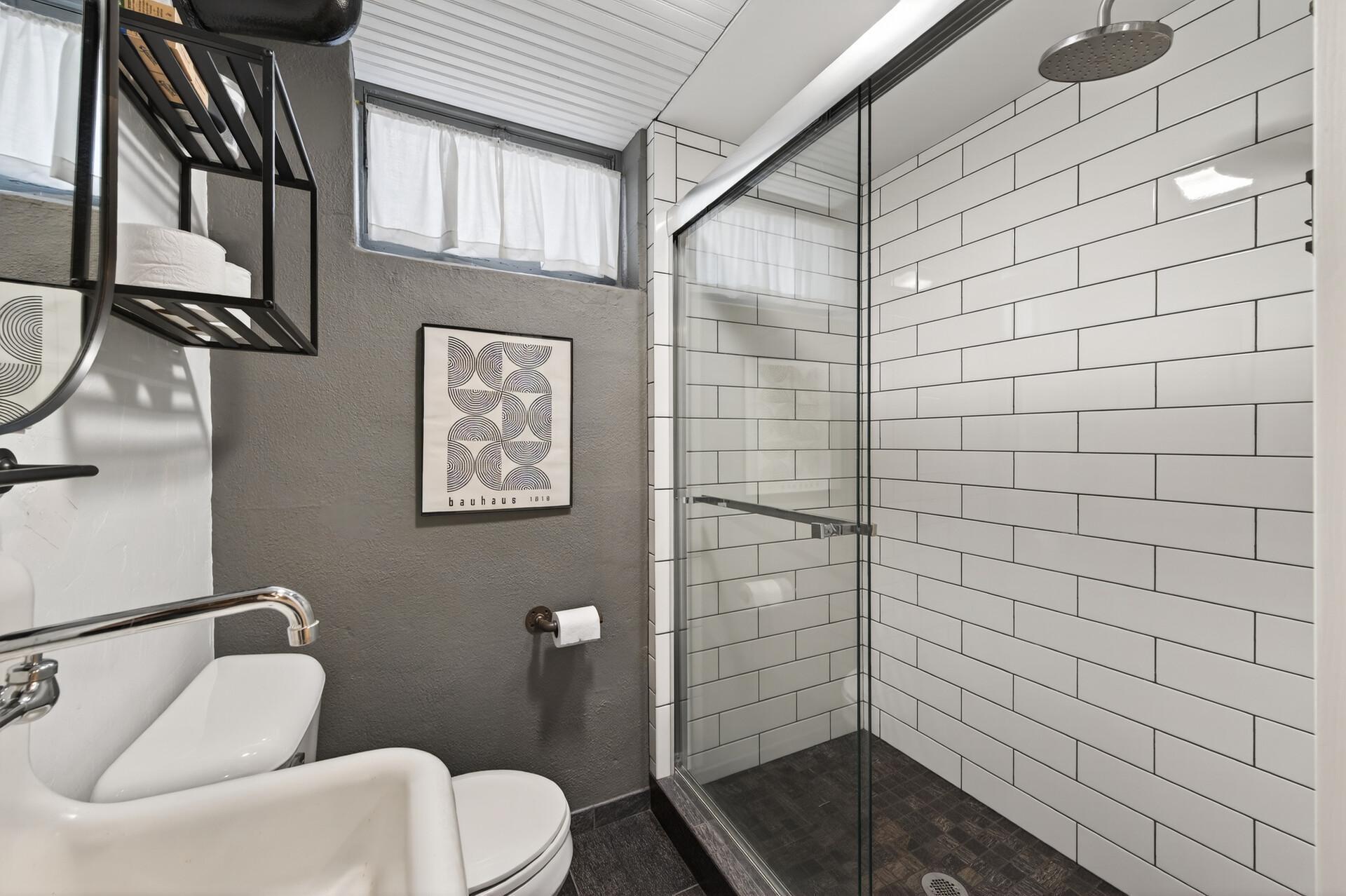 Lower level walk-in tiled shower.