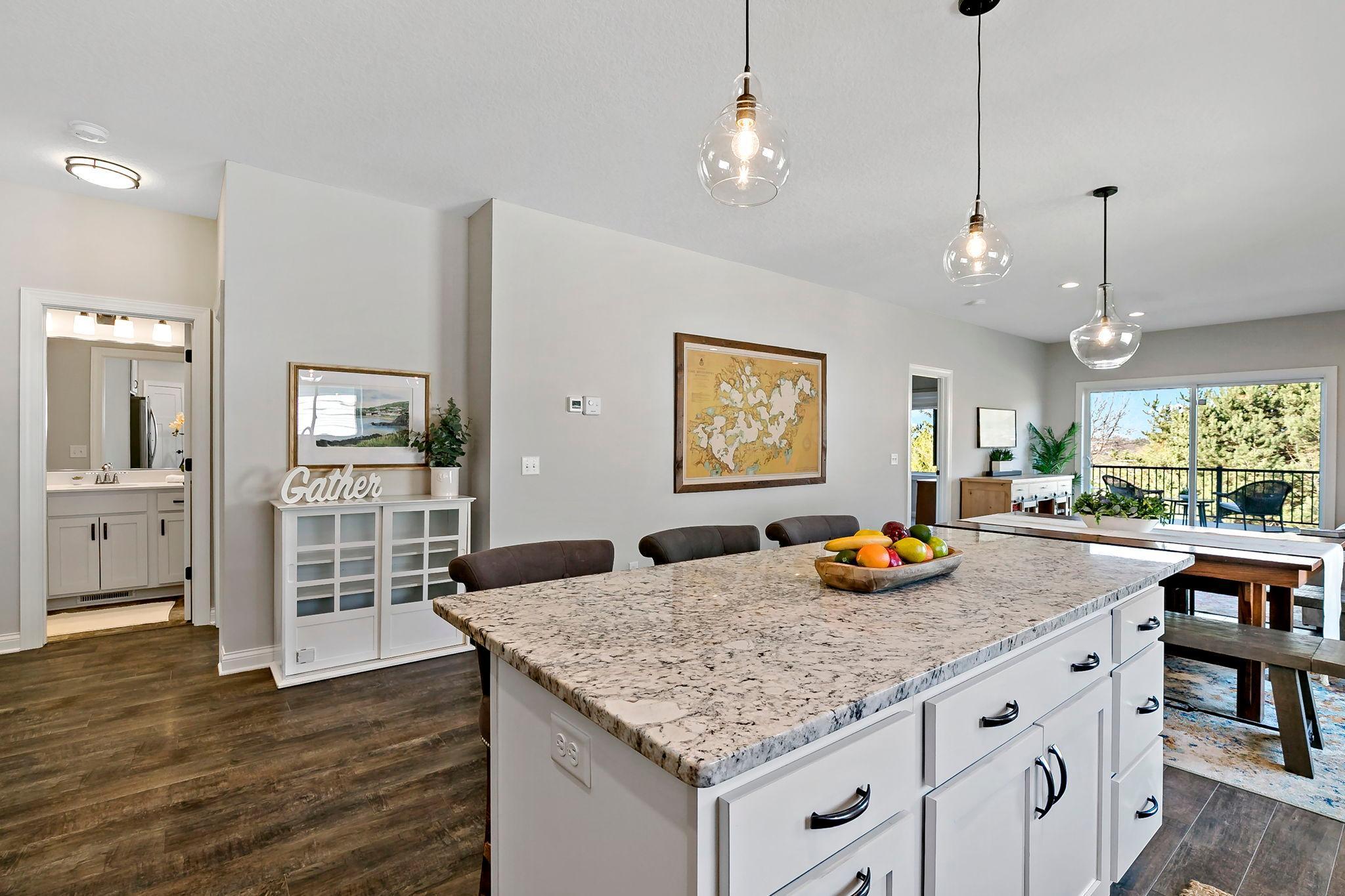 Spacious open kitchen and dining area with oversized granite island.